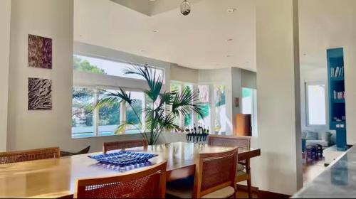 a dining room with a table with chairs and a plant at Estoril dream in Estoril