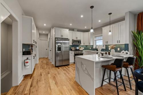 a kitchen with white cabinets and stainless steel appliances at 2br 3ba 2King bd 3 Car Parking Bonus area with Queen Bed in East Newark