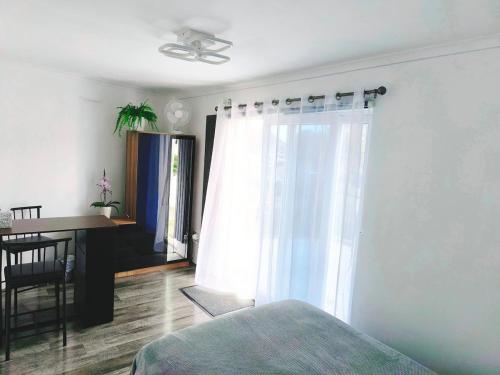 a bedroom with a bed and a desk and a window at Modern Oasis , Edinburgh Airport near,8mi in Rosyth