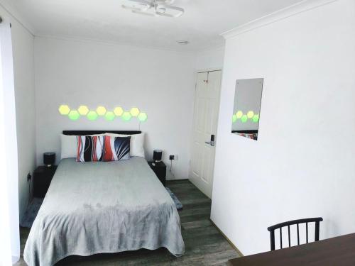 a white bedroom with a bed and a table at Modern Oasis , Edinburgh Airport near,8mi in Rosyth