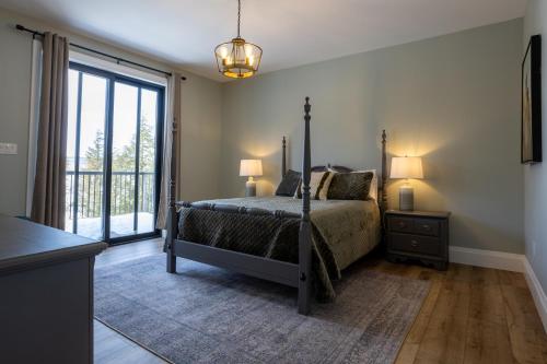 a bedroom with a bed and a large window at Algonquin Park,Sunset Paradise with Private Beach in Madawaska
