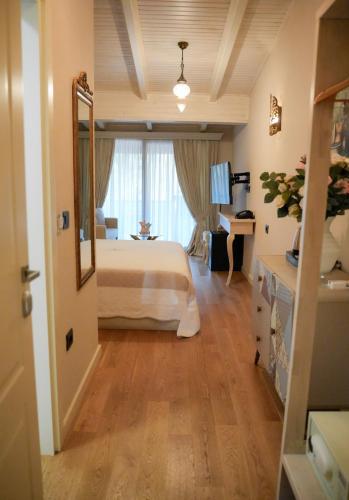 a bedroom with a bed and a large window at Le prince Rooms in Tirana