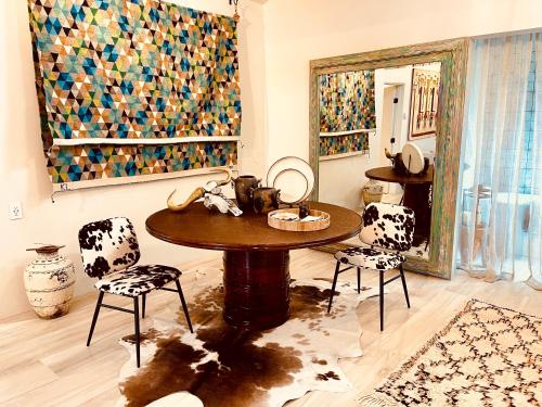 a room with a table and chairs and a mirror at CASA TUA SANTA FE - NM Farmhouse Sanctuary Soaking Room 1 acre private in Santa Fe