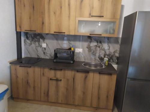 a kitchen counter with a sink and a refrigerator at Bakery apartments in Perea