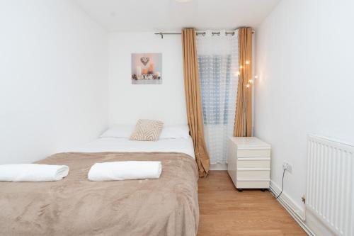 a white bedroom with a bed and a window at Amazing Lodge in Southampton