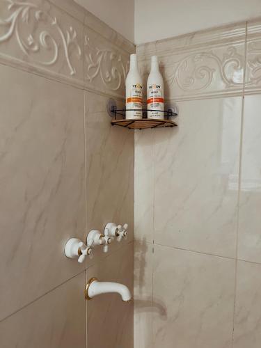 a bathroom with a shower with two bottles on the wall at Departamento monoambiente en el centro de San Isidro in San Isidro