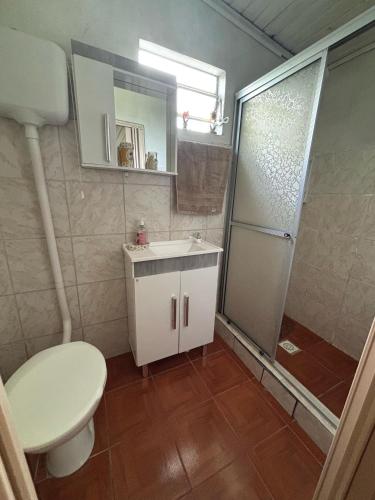 a bathroom with a toilet and a sink and a shower at Casa Hospedes in Canela