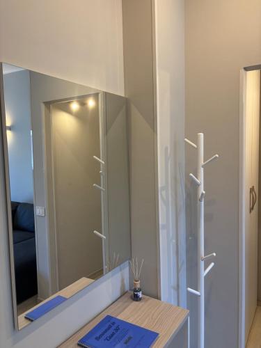 a bathroom with a mirror and a wooden table at Casa30 in Monza