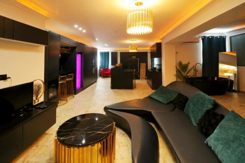 a living room with a couch and a table at OLGA Luxury Suite I 5 min from airport I central location I traditional village in Luqa