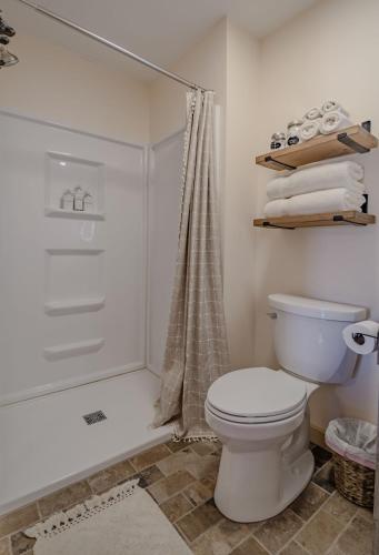 a bathroom with a toilet and a shower at The Inn at Beulah Farm - The Barn in Whitley City