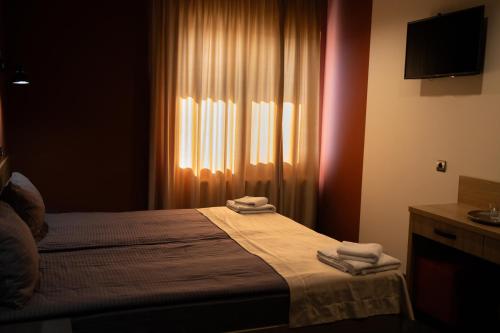 Ένα ή περισσότερα κρεβάτια σε δωμάτιο στο House Inn