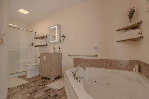 a bathroom with a bath tub and a toilet at The Inn at Beulah Farm - The Garden in Whitley City