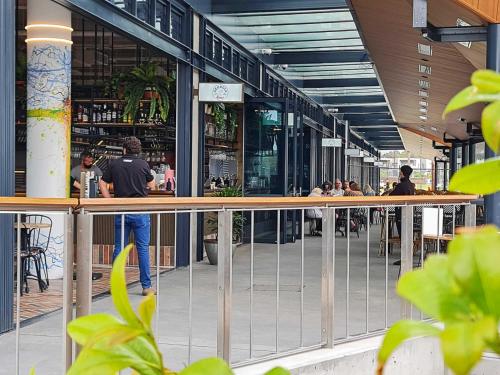 a man standing at the bar of a restaurant at Seaside Village Retreat in Shellharbour