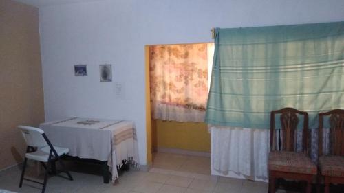 a room with a table and a chair and a window at Casa Ana Liz in Oaxaca City