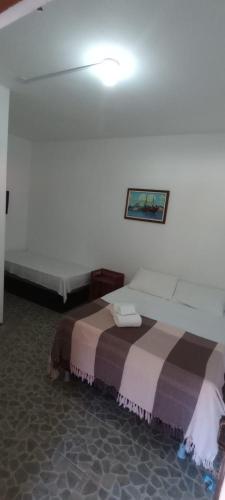 a bedroom with two beds in a room at Bromelias Imbassai in Imbassai