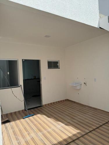 an empty room with white walls and a wooden floor at Bromelias Imbassai in Imbassai