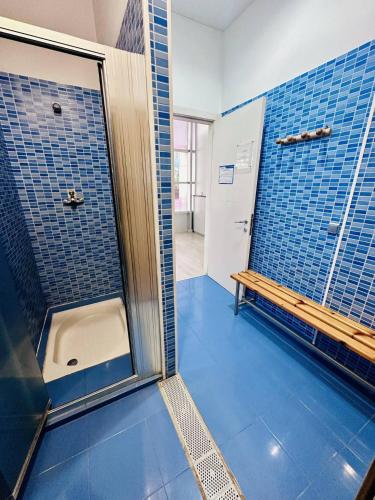 a bathroom with a shower with a bench in it at Apartamento Elegance Benidorm La Cala in Benidorm