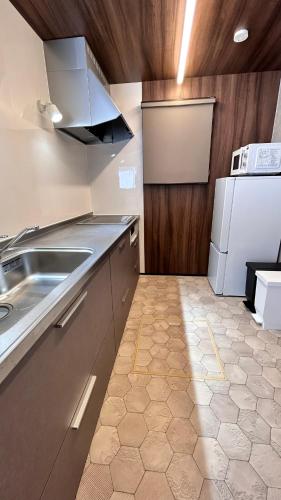 a kitchen with a sink and a refrigerator at HiL town yamanashi 26 LIAN in Kofu