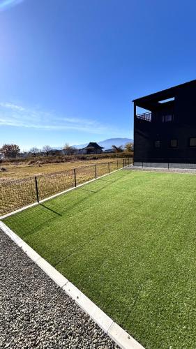 a field of green grass next to a building at HiL town yamanashi 26 LIAN in Kofu