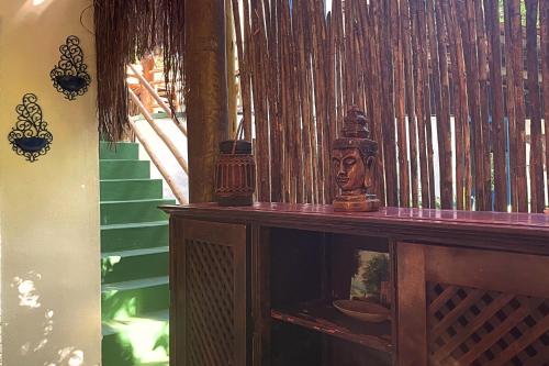 a wooden cabinet with a statue on top of it at Vila Coco Dendê - Algodões in Marau