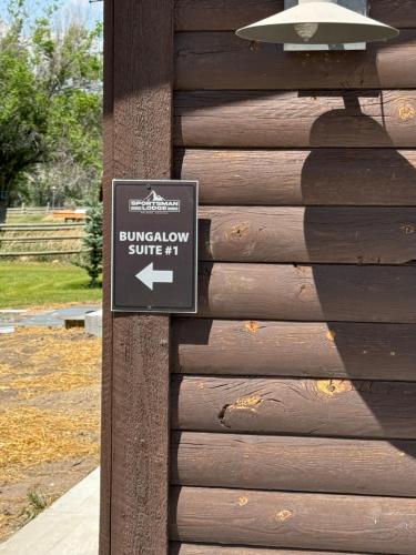 a sign on the side of a wooden building at Sportsman Lodge Melrose MT in Melrose