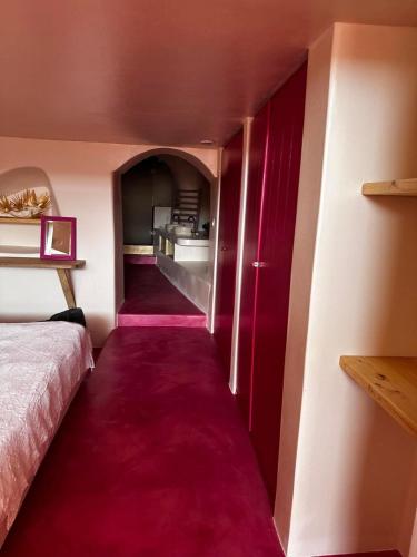 a room with a bed and a red carpet at Maria Paradeiso Resorts in Imerovigli