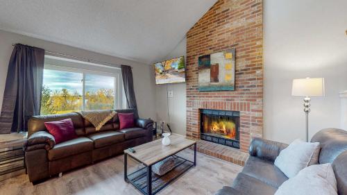a living room with a couch and a fireplace at Comfortable Family Friendly Home on Quincy Reservoir in Aurora