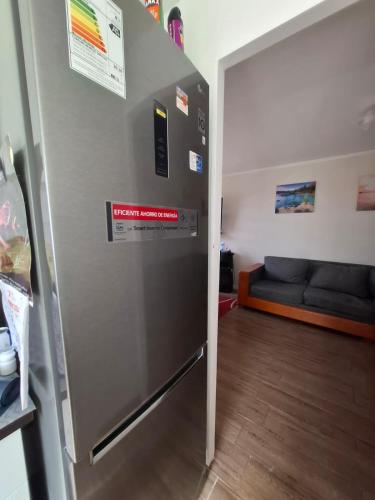 a refrigerator in a living room with a couch at Nicolle Reyes's House in Coquimbo