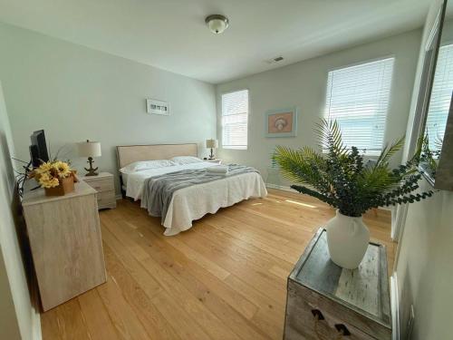 a bedroom with a bed and a vase on a table at Golf Resort, Beach, Entire House in Myrtle Beach