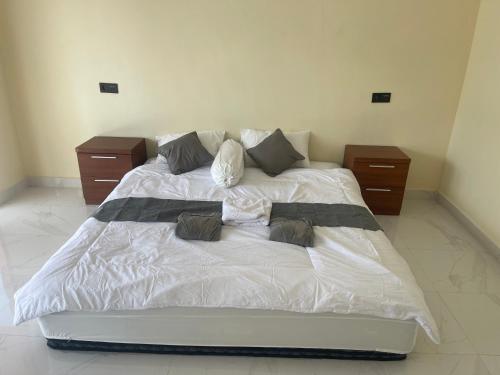 a bed in a bedroom with two night stands at Saris Sweet Dream Villa in Kubupenlokan