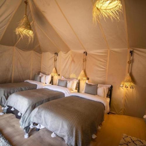 Ένα ή περισσότερα κρεβάτια σε δωμάτιο στο Merzouga Spectacular Luxury Camp