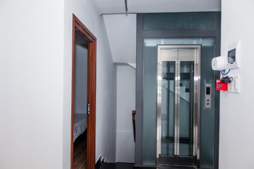 a hallway with a glass elevator in a room at Suka Hotel in Tây Ninh