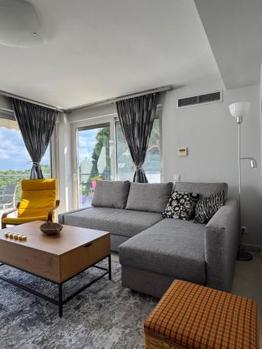 a living room with a couch and a table at HalCyon-On the blue in Nea Makri