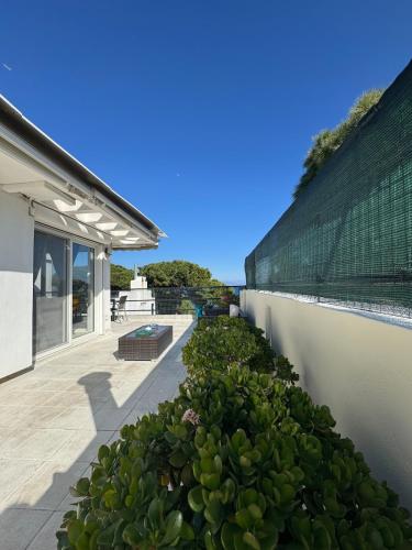 a retaining wall with plants next to a building at HalCyon-On the blue in Nea Makri