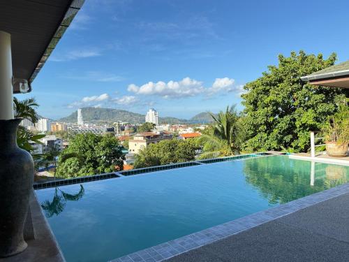 a swimming pool with a view of the city at Over the Moon villa in Patong Beach