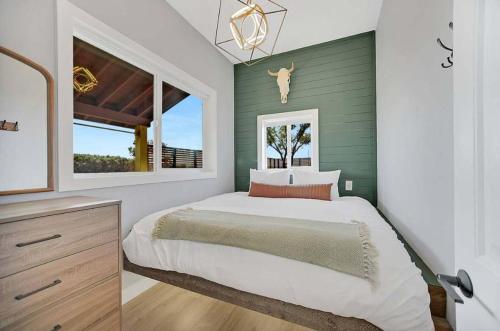 a bedroom with a large bed and a window at 25 Min to Grand Canyon Shuffleboard Fire Pit in Valle