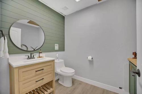 a bathroom with a white toilet and a mirror at 25 Min to Grand Canyon Shuffleboard Fire Pit in Valle