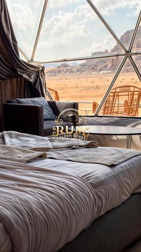 a bed on a boat with a view of the desert at RUM GOLDEN DUNE lUXURY RESORT in Wadi Rum