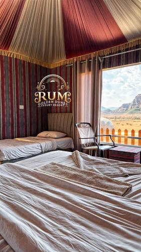 a hotel room with two beds and a sign on the wall at RUM GOLDEN DUNE lUXURY RESORT in Wadi Rum