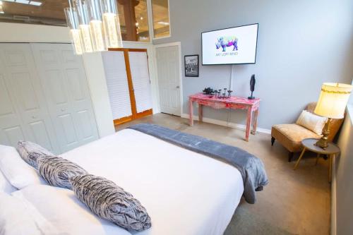 a bedroom with a white bed and a red table at Trendy Modern Loft in Rino Art District in Denver