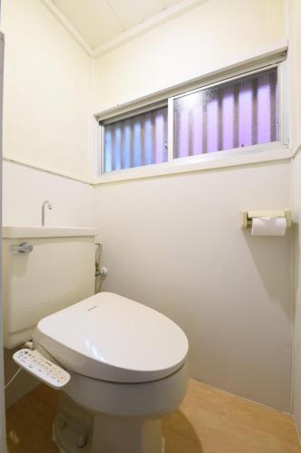 a bathroom with a white toilet and a window at Grandma's house - おばあちゃん家 in Numazu