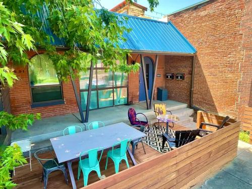 a patio with a blue table and chairs at Trendy Modern Loft in Rino Art District in Denver