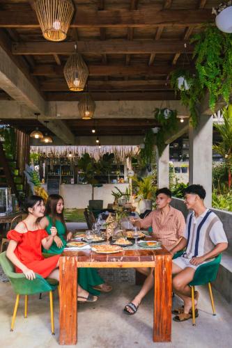 a group of people sitting around a table at Bintana sa Paraiso Binunsaran in Mambajao