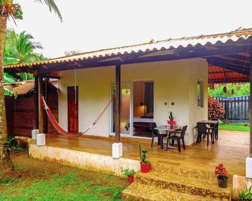 a villa with a deck and a bedroom at Casa Mariposa Puertolindo in Garrote