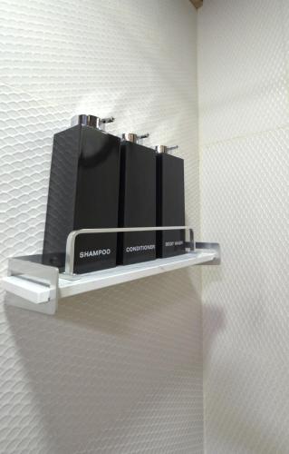 a shelf with two appliances sitting on a wall at Coco Cabana in the Jungle in Sarapiquí