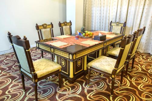 a dining room table with chairs and a bowl of fruit at Rose View Hotel in Sylhet