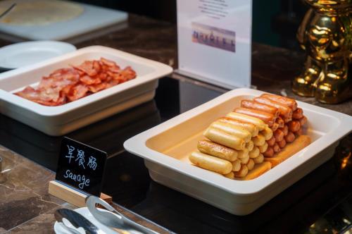 two white bowls of food on a counter with food at Novotel Nanjing Airport in Nanjing