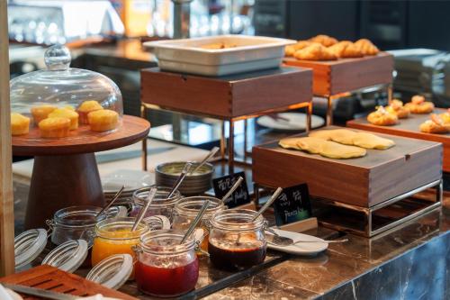 a buffet with various types of bread and pastries at Novotel Nanjing Airport in Nanjing