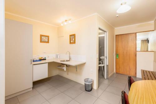a small kitchen with a sink and a table at Methven Resort in Methven