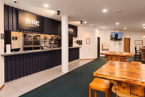 a restaurant with wooden tables and a bar at Methven Resort in Methven